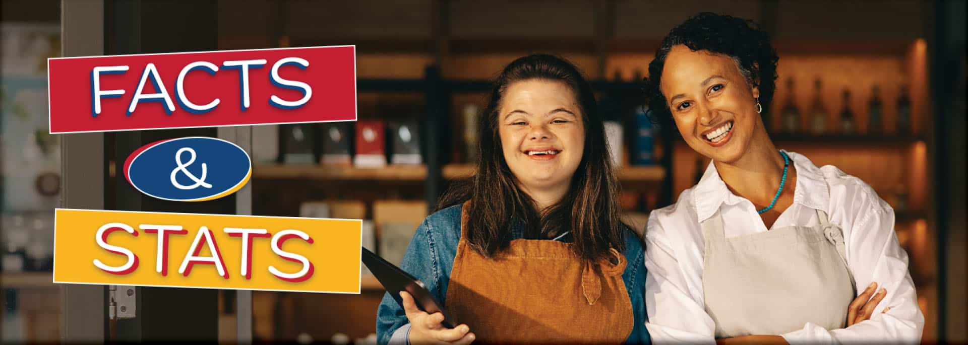 A person with Down syndrome and their co-worker working and smiling together ready to take questions and answers from peers